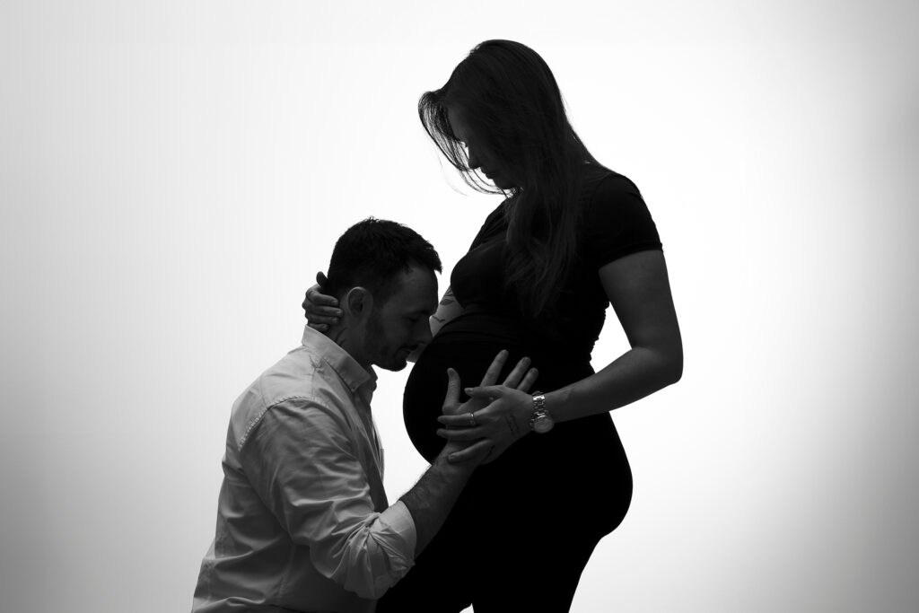 Photo de grossesse dont le mari embrasse le ventre